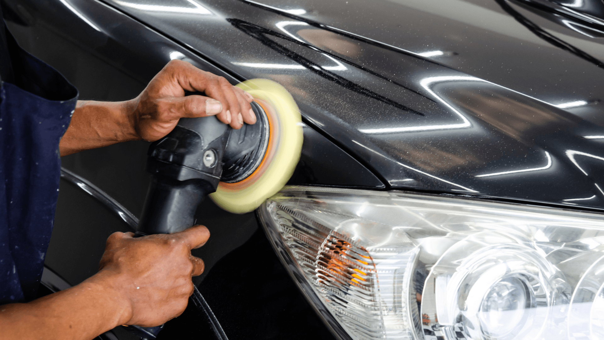 Technician polishing a fender